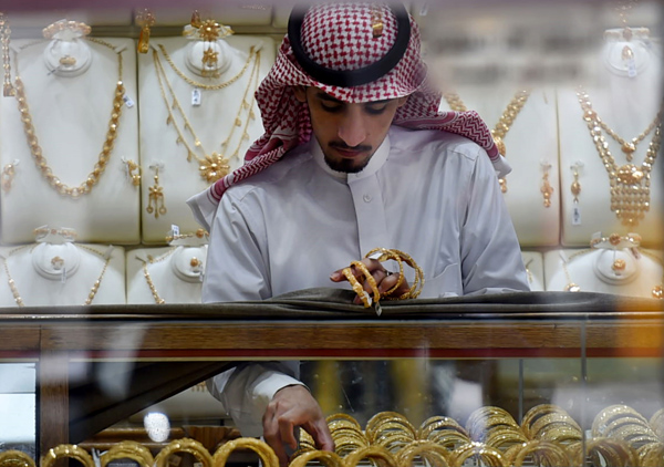 A Saudi man displays gold bracelets at his jewellery shop in Tiba market in the capital Riyadh on Monday (AFP photo)